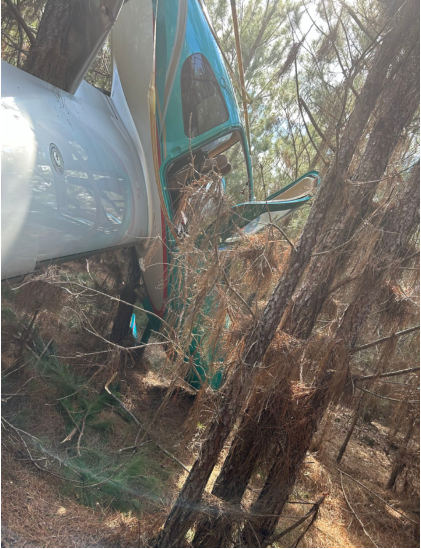 Photograph 1 – Airplane suspended in the trees at the accident site., from the NTSB investigation of Cirrus Design CORP SR22 accident near Winokur, Georgia, March 16, 2024