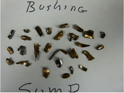 Photograph 7 – Bushing pieces discovered in sump., from the NTSB investigation of Cirrus Design CORP SR22 accident near Winokur, Georgia, March 16, 2024