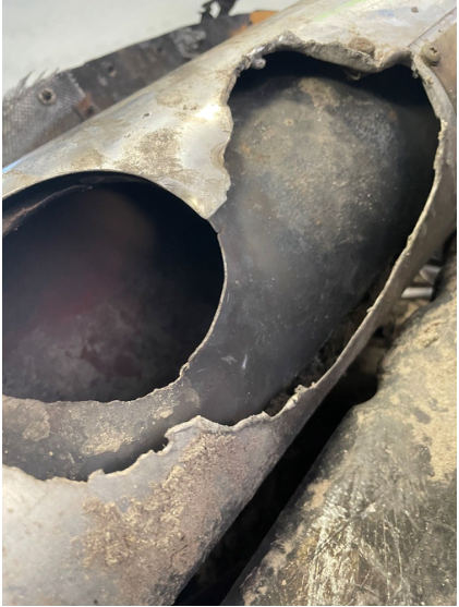 INVESTIGATIVE PHOTOS Photograph 3 – Muffler with missing pipe and melted cover., from the NTSB investigation of Amateur-built Sportsman 2+2 accident near Fort Meade, Florida, March 14, 2024