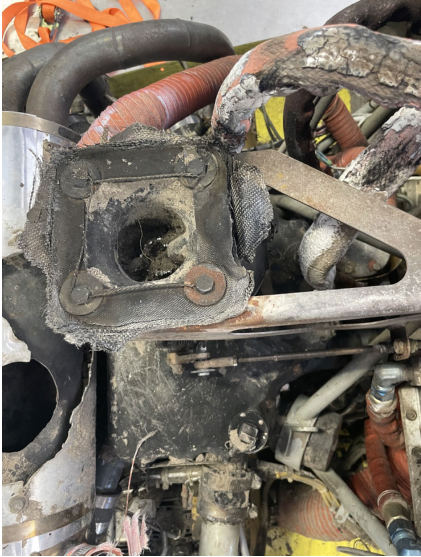 INVESTIGATIVE PHOTOS Photograph 4 – Melted carburetor and fuel lines., from the NTSB investigation of Amateur-built Sportsman 2+2 accident near Fort Meade, Florida, March 14, 2024