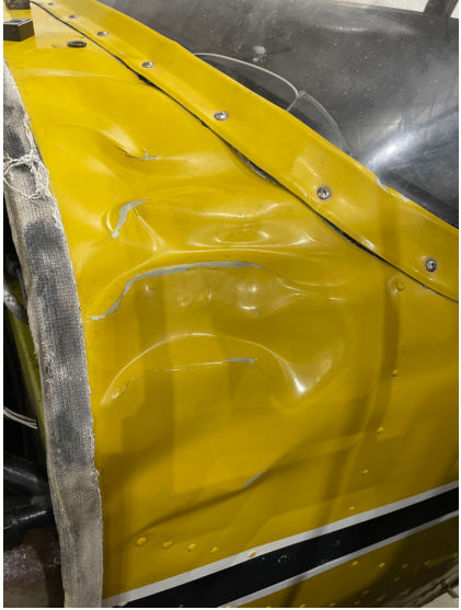 Photograph 5 – Left Side View of the Forward Fuselage. Noted the Extensive Skin Damage Aft of the Firewall, from the NTSB investigation of Piper PA-24-250 accident near North Kingstown, Rhode Island, March 30, 2024