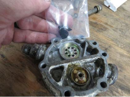 Photograph 6 – View of the Disassembled Engine-Driven Fuel Pump Showing the Foreign Object Found Inside the Pump, from the NTSB investigation of Piper PA-24-250 accident near North Kingstown, Rhode Island, March 30, 2024