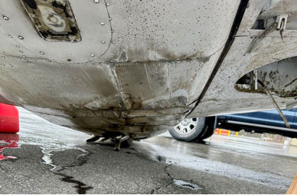 Photograph 4 – Damage to lower fuselage, from the NTSB investigation of Piper PA-24-250 accident near Carrabassett, Maine, April 8, 2024