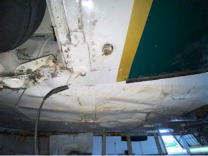Photograph 4 – Lower Fuselage Damage, from the NTSB investigation of Beech 95B55 accident near St. Augustine, Florida, April 1, 2024