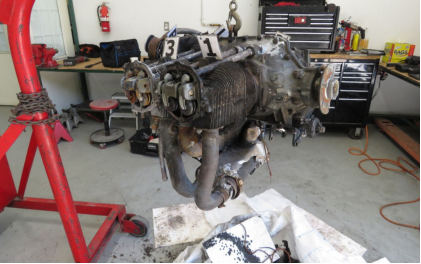 Photograph 8 – View of number 1 and 3 side of engine on hoist. (NTSB), from the NTSB investigation of Piper PA-28-151 accident near Hope Mills, North Carolina, May 26, 2024