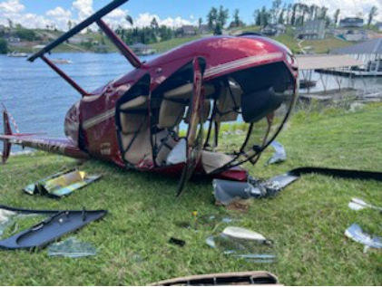 Photograph 2 – Inverted helicopter from front left, from the NTSB investigation of Robinson R44 accident near Gilbertsville, Kentucky, June 2, 2024