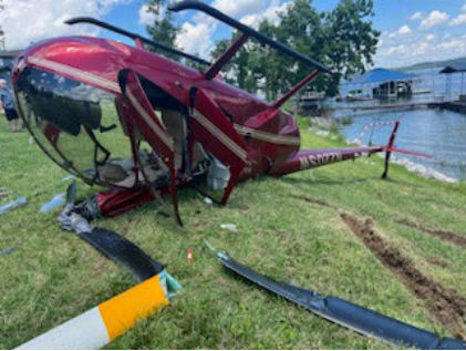 Photograph 3 – Inverted helicopter from front right, from the NTSB investigation of Robinson R44 accident near Gilbertsville, Kentucky, June 2, 2024