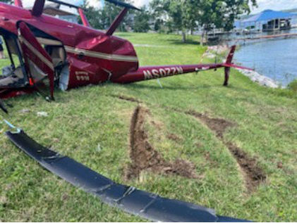 Photograph 4 – View of ground scars and wreckage, from the NTSB investigation of Robinson R44 accident near Gilbertsville, Kentucky, June 2, 2024