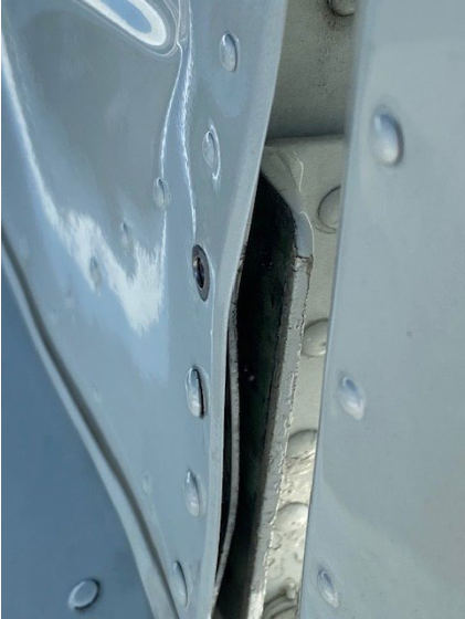 INVESTIGATIVE PHOTOS Photograph 1 – Left side vertical stabilizer with missing rivet, from the NTSB investigation of Piper PA28R accident near Vero Beach, Florida, June 7, 2024