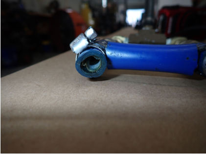 Photograph 6 – Partially occluded fuel hose from fuel pump outlet manifold, from the NTSB investigation of Amateur-built AVENTURA II accident near Deland, Florida, June 26, 2024