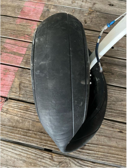 Photograph 6 – Right main landing gear tire, from the NTSB investigation of Cessna A185F accident near Rural Retreat, Virginia, July 21, 2024