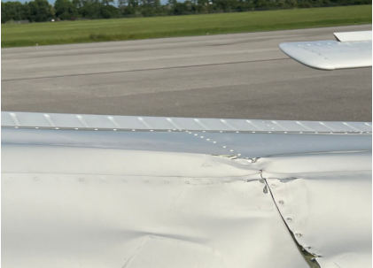 Photograph 5 - Damage to low-wing airplane’s wing, from the NTSB investigation of Cessna 172N and Piper PA-28-161 accident near Immokalee, Florida, July 28, 2024
