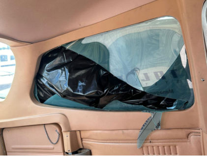 Photograph 7 – Damage to high wing airplane’s window, from the NTSB investigation of Cessna 172N and Piper PA-28-161 accident near Immokalee, Florida, July 28, 2024