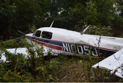 Photograph 2 – FAA Digital Photograph. Left Rear Quartering View of the Airplane At the Accident Site. Note the Compression Wrinkles in the Left Side of the Fuselage, from the NTSB investigation of Mooney M20K accident near Fairmont, West Virginia, August 30, 2024