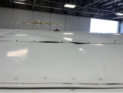 Photograph 3 – Right wing impact damage buckling, from the NTSB investigation of Cessna 150 accident near Erie, Pennsylvania, September 22, 2024