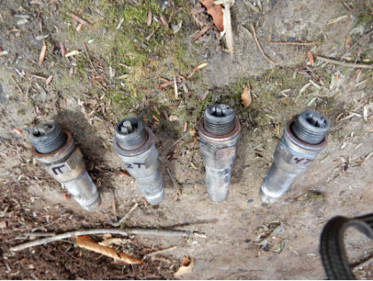 Photograph 11 – Top Spark Plugs (NTSB Photo), from the NTSB investigation of Cessna 150F accident near Wilder, Tennessee, October 31, 2024