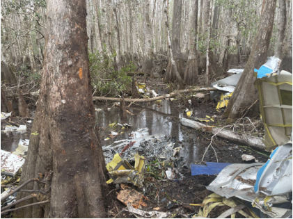 Photograph 4 – View of fragmented wreckage in swamp. (NTSB), from the NTSB investigation of Cessna 208 accident near Pierson, Florida, February 14, 2025