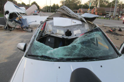 Photograph 2 – Damaged car and airplane at accident site, from the NTSB investigation of Piper PA28 accident near Louisville, Kentucky, October 11, 2024