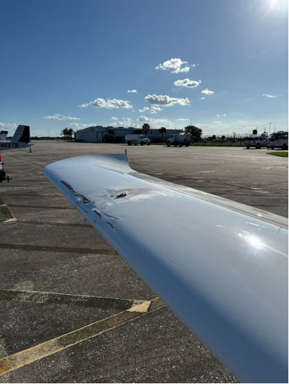 Photograph 1 – Left Side View of Right Wing Damage, from the NTSB investigation of Cirrus Design CORP SR20 accident near Sebring, Florida, October 24, 2024