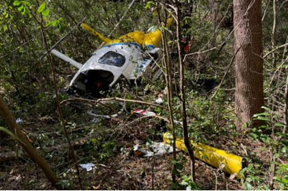 Photograph 1 – View of damaged helicopter and separated tail boom., from the NTSB investigation of Hughes 369D accident near Waycross, Georgia, November 5, 2024