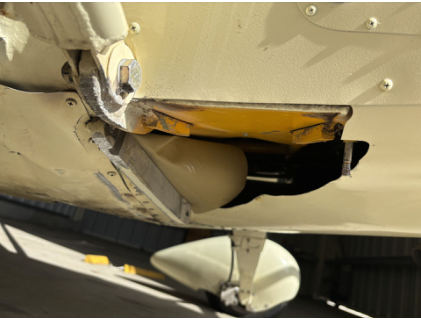 Photograph 6 – Postaccident damaged landing gear attach bracket and lower wing strut attach fitting, from the NTSB investigation of Amateur-built BAKENG DUCE accident near Plant City, Florida, November 17, 2024
