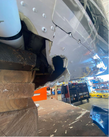 Photograph 1 – Close-up view of helicopter hull showing skid damage, from the NTSB investigation of Bell 206B accident near Lakeland, Florida, November 21, 2024
