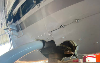 Photograph 2 – Close-up rear view of helicopter hull damage, from the NTSB investigation of Bell 206B accident near Lakeland, Florida, November 21, 2024