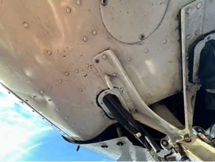 Photograph 1 – Skin deformation noted to lower left fuselage, from the NTSB investigation of Cessna 172 accident near Jefferson, Georgia, December 12, 2024