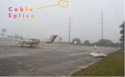 Photograph 7 – Repaired Wire in Relation to the Airplane (Courtesy FAA), from the NTSB investigation of Beech BE-76 accident near Melbourne, Florida, December 26, 2024