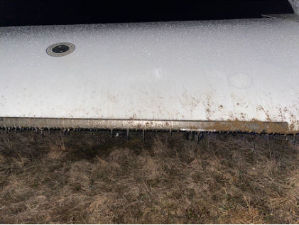 Photograph 5 – FAA Digital Photograph. View of a portion of the Right Wing. Note Dirt on the Leading Edge on Top of a Layer of Ice, from the NTSB investigation of Cirrus Design CORP SR22 accident near New Lexington, Ohio, February 5, 2025