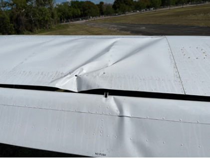 Photograph 2 – Deformation noted to left wing structure, from the NTSB investigation of Cessna Aircraft CO 162 accident near Miami, Florida, March 19, 2025