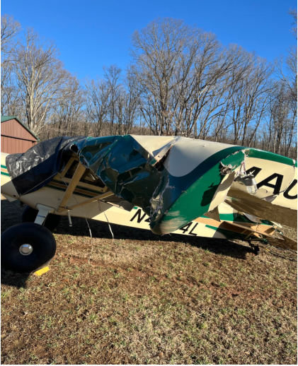 Photograph 2 – View of green and white airplane left side buckled wing., from the NTSB investigation of Maule M7 accident near Birdsboro, Pennsylvania, March 20, 2025