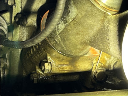 Photograph 3 – Oil filter adapter, Note: gasket protruding and leaking oil, from the NTSB investigation of Beech E33 accident near Lenoir, North Carolina, February 25, 2025
