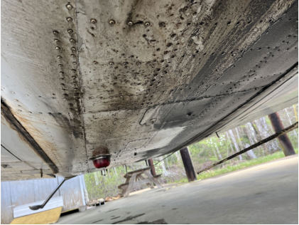Photograph 4 – Bottom of fuselage covered in oil, from the NTSB investigation of Beech E33 accident near Lenoir, North Carolina, February 25, 2025