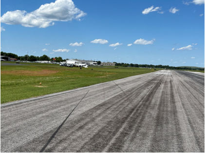 Photograph 3 – View of tire skid marks into the grass of the left side of the runway., from the NTSB investigation of Cessna 172N accident near Murfreesboro, Tennessee, May 22, 2025