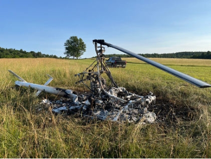 Photograph 2 – Right-side view of upright post-crash fire damaged helicopter., from the NTSB investigation of Amateur-built ROTORWAY EXEC 162F accident near Towanda, Pennsylvania, July 4, 2025