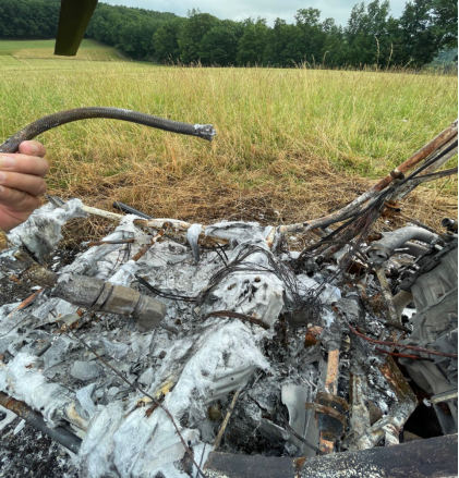 Photograph 6 – View of fire damaged fuel lines., from the NTSB investigation of Amateur-built ROTORWAY EXEC 162F accident near Towanda, Pennsylvania, July 4, 2025