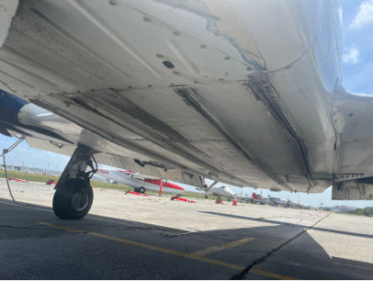 Photograph 5 – View of the Fuselage Bottom Noting Damage to External Longerons, from the NTSB investigation of Piper PA34 accident near Fort Lauderdale, Florida, July 10, 2025