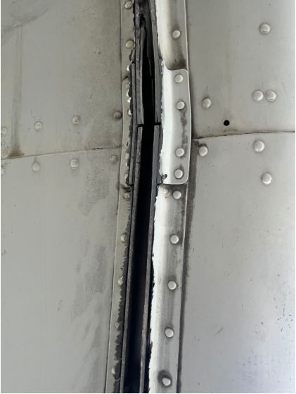 Photograph 6 – Close-Up View Showing Damage to External Longeron, from the NTSB investigation of Piper PA34 accident near Fort Lauderdale, Florida, July 10, 2025