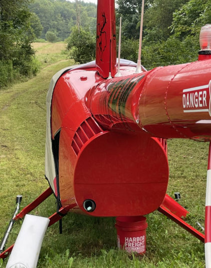 Photograph 1 – View of damage to the tail boom., from the NTSB investigation of Robinson Helicopter Company R44 II accident near Inlet, New York, July 9, 2025