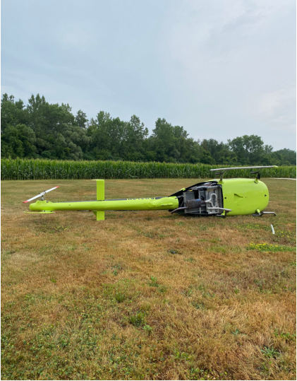 Photograph 1 – Bottom View of the Helicopter Resting on Its Left Side, from the NTSB investigation of Amateur-built EXEC 162F accident near Holley, New York, July 30, 2025