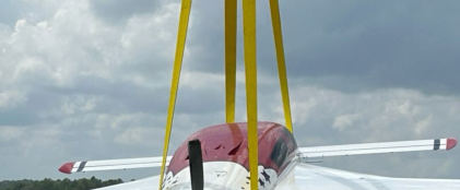 Photograph 2 – Airplane being lifted on runway, NOTE: landing gear down and locked, from the NTSB investigation of Amateur-built VELOCITY XL RG accident near Columbia, South Carolina, August 12, 2025