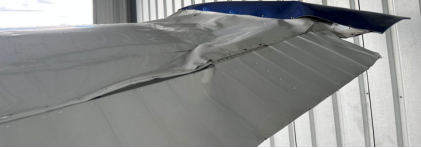 Photograph 3 – View of topside of right wing bent tip., from the NTSB investigation of Cessna 170B accident near Knoxville, Tennessee, August 25, 2025