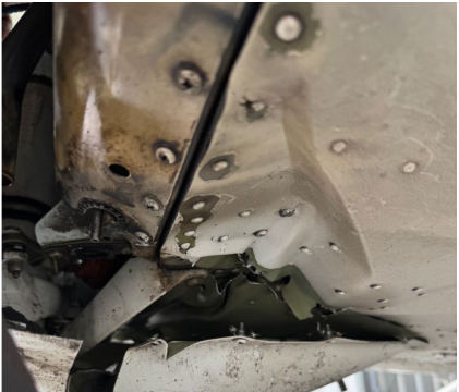 Photograph 2 – View of underside of fuselage behind firewall showing substantial damage, from the NTSB investigation of Cessna T182T accident near Venice, Florida, October 4, 2025