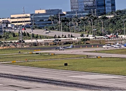 Photograph 3 – Airport CCTV of Accident, from the NTSB investigation of Akrotech Aviation INC GILES G-202 and Cessna 172R accident near Boca Raton, Florida, October 28, 2025