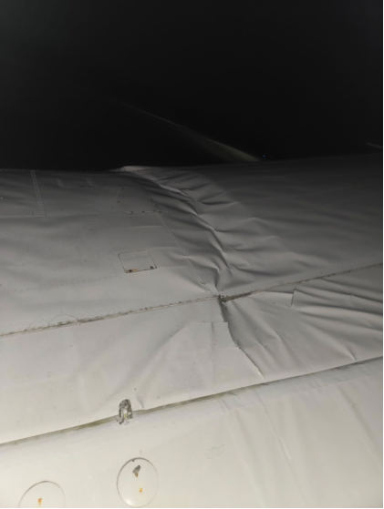 Photograph 2 – Left wing upper skin damage and spar buckling, from the NTSB investigation of Consolidated Vultee 28-5ACF accident near Dayton, Tennessee, October 31, 2025