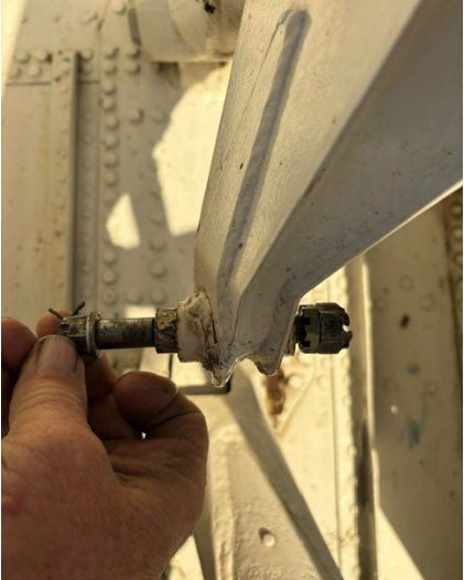 Photograph 6 – Left Main Landing gear sheared actuator bolt, from the NTSB investigation of Consolidated Vultee 28-5ACF accident near Dayton, Tennessee, October 31, 2025