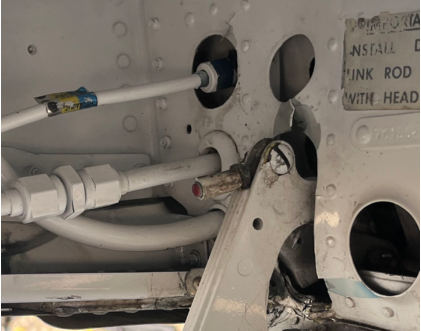 Photograph 4 – Failed Left Inboard Gear Door Link Assembly, from the NTSB investigation of Beech 95-B55 accident near Dothan, Alabama, November 14, 2025