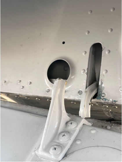 Photograph 5 – Failed Left Aft Inboard Door Hinge, from the NTSB investigation of Beech 95-B55 accident near Dothan, Alabama, November 14, 2025