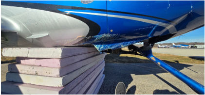 Photograph 2 – Lower fuselage Damage, from the NTSB investigation of Cirrus Design CORP SR22 accident near Blue Bell, Pennsylvania, December 7, 2025